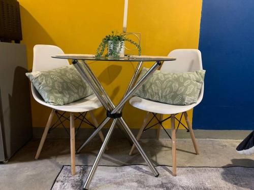 a table and chairs with a plant on top of it at Just Vibes at 0953 Maboneng Precinct in Johannesburg