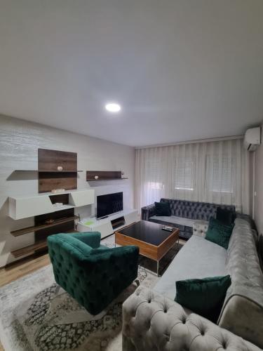 a living room with a couch and two chairs at Avio Lux Apartmani in Novi Pazar