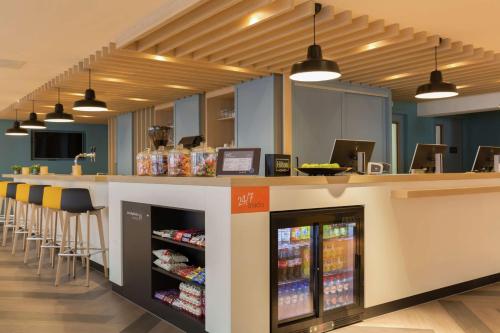 a store with a counter and a bar with drinks at Hampton By Hilton Antwerp Central Station in Antwerp