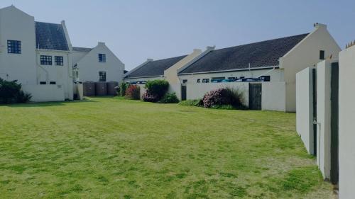a large yard with houses and grass at Beachfront at 22 Settler's Sands in Port Alfred