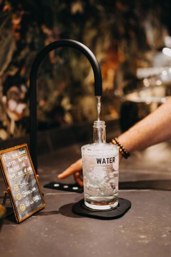 a bottle of water sitting on top of a table at Hotel Astoria Gent in Ghent