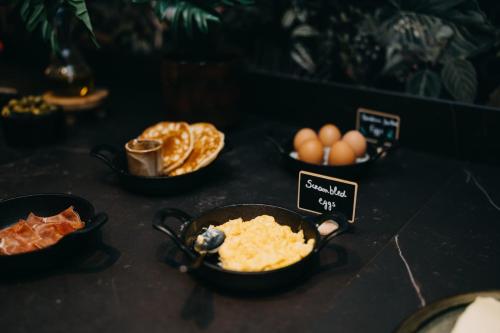 a table topped with bowls of food and eggs at Hotel Astoria Gent in Ghent