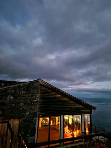 a log cabin with a view of the ocean at Lava Homes in Santo Amaro