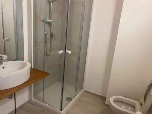 a bathroom with a shower and a sink and a toilet at Villa Vinci in Recanati