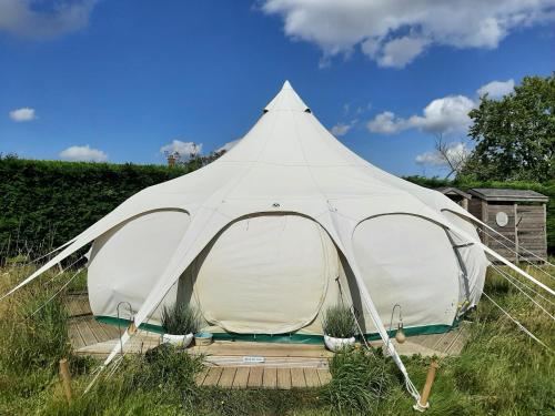 a large white tent sitting in a field at Wild Retreat in Cawston