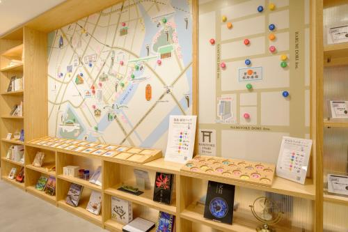 a library with a map on the wall at Tosei Hotel Cocone Tsukiji Ginza Premier in Tokyo