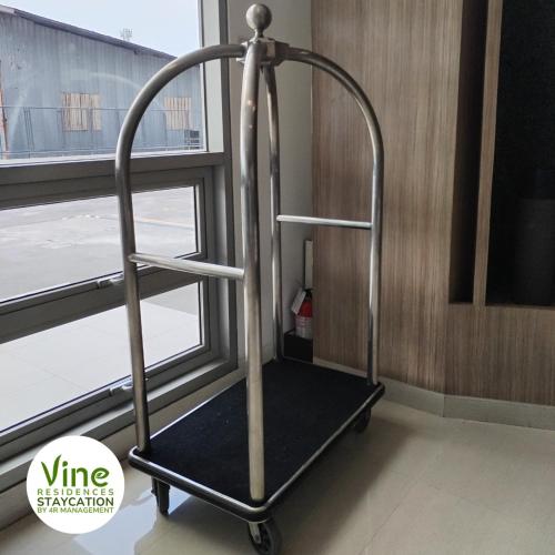 - un chariot à bagages métallique dans une chambre avec fenêtre dans l'établissement Vine Residences Staycation, à Manille