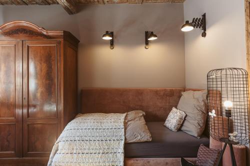 a bedroom with a bed with a wooden head board at Flecksches Gut in Leipzig