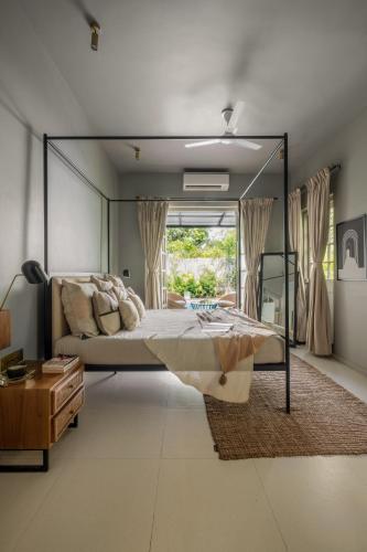 a bedroom with a large bed with a large mirror at LohonoStays Castello Villa 1 in Vagator