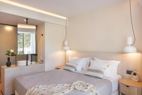 a bedroom with a large bed and a mirror at Erato by Samian Mare in Karlovasi