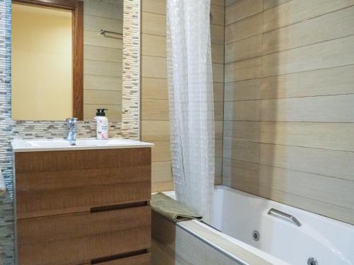 a bathroom with a tub and a sink and a shower at Tarragona Ciudad, El Serrallo AP-1 in Tarragona