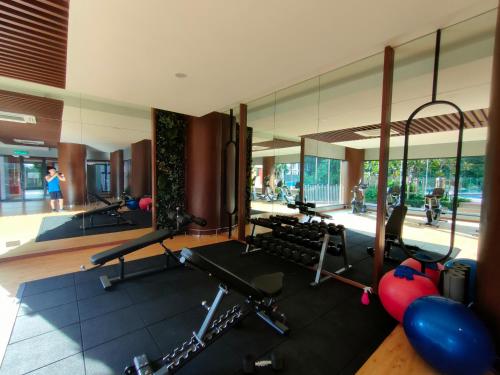 a gym with cardio equipment and a mirror at Budget Homestay by The RUM in Putrajaya