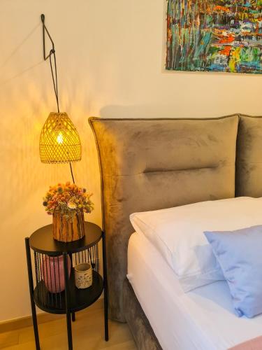 a bedroom with a bed and a table with a lamp at Apartment TORRE - NEW in Senj