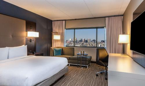 a hotel room with a bed and a large window at DoubleTree by Hilton Hotel Newark Airport in Newark