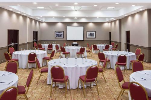 a conference room with tables and chairs and a whiteboard at DoubleTree by Hilton Hotel Newark Airport in Newark