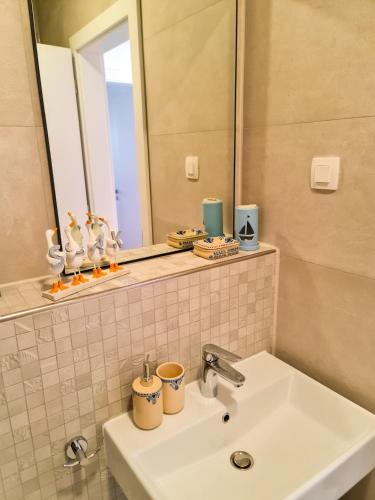 a bathroom with a sink and a mirror at Apartment TORRE - NEW in Senj