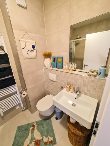 a bathroom with a sink and a toilet and a mirror at Apartment TORRE - NEW in Senj