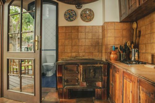 a kitchen with a counter and a toilet in it at Stara Kuźnia- Domek w Puszczy Noteckiej in Zatom Nowy