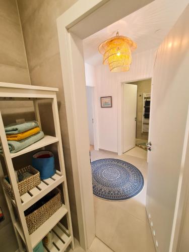 a hallway with a door leading into a room with a chandelier at Apartment TORRE - NEW in Senj