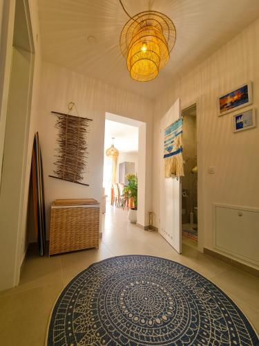 a hallway with a rug on the floor and a chandelier at Apartment TORRE - NEW in Senj