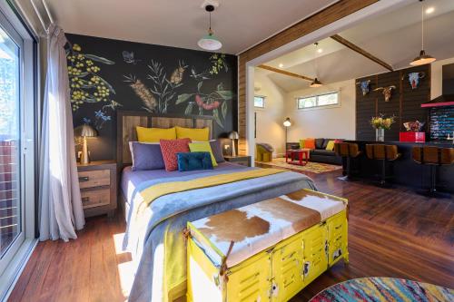 a bedroom with a large bed with a yellow drawer at Studio 22 Bellingen in Bellingen