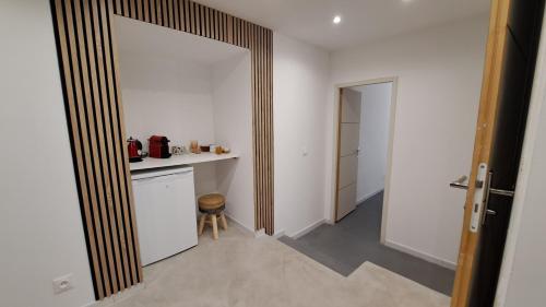 a room with a kitchen with a counter and a door at Les chambres du Chateau de Fenestrelle in Aubagne