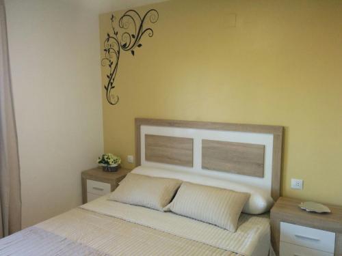 a bedroom with a large bed with a white headboard at Apartamentos Serenity in Peniscola