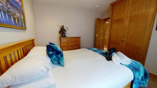 a bedroom with two beds with blue pillows on them at Meadow View in Crawley