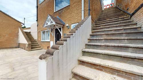 a set of stairs leading up to a brick building at Meadow View in Crawley