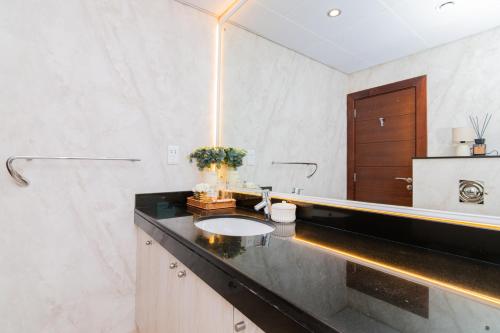 a bathroom with a sink and a mirror at Cozy 2BR Delux Apartment in Dubai Marina in Dubai