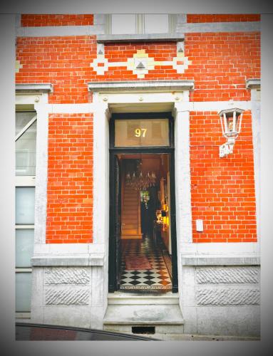 a red brick building with a door with the number at Hôtel VCB Ciney Centre-ville in Ciney