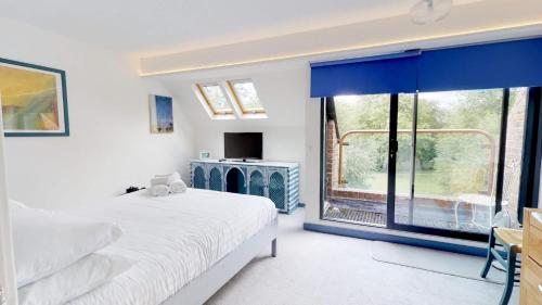 een slaapkamer met een bed en een groot raam bij Thames View In Oxford in Oxford
