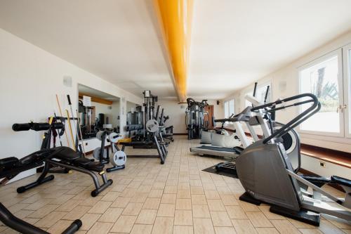 a gym with several treadmills and exercise bikes at Poiano Garda Resort Appartamenti in Garda