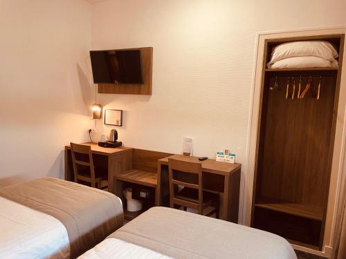 Ein Bett oder Betten in einem Zimmer der Unterkunft Logis Le Passiflore Cognac