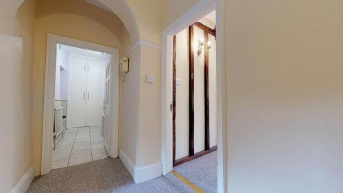 an empty hallway with a hallway leading to a room at Market Place Cottage in Woodstock