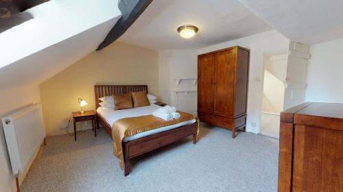 a small bedroom with a bed and a dresser at Market Place Cottage in Woodstock