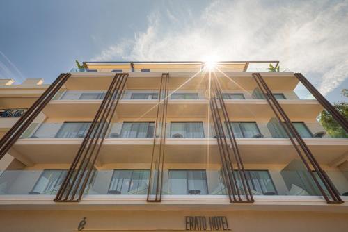 a building with the sun shining through the windows at Erato by Samian Mare in Karlovasi