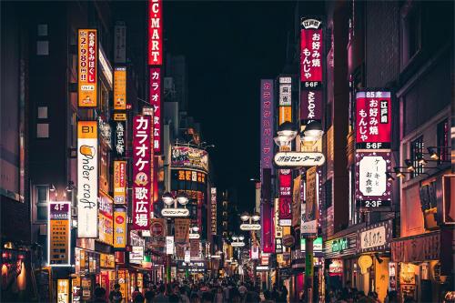 a busy city street at night with neon signs at 上野超豪华4人间 东京超级中心Ydoa 设计师房间 上野公园3分钟 车站1分钟 超级繁华 免费wifi 戴森吹风 in Tokyo