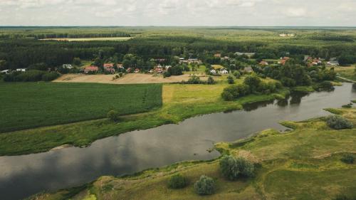 an aerial view of a river and a village at Stara Kuźnia- Domek w Puszczy Noteckiej in Zatom Nowy
