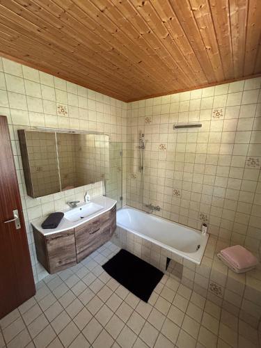 a bathroom with a tub and a sink and a mirror at Tina a Petr , Lunz am See in Lunz am See