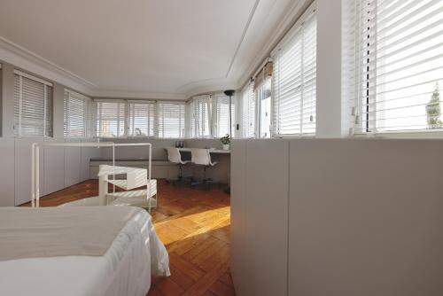 a bedroom with a bed and a desk and a table at Boavista Sunlit Duplex with Terrace in Porto