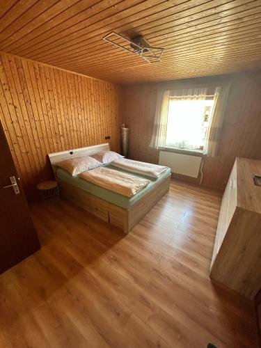 a bedroom with a bed in a room with a wooden ceiling at Tina a Petr , Lunz am See in Lunz am See