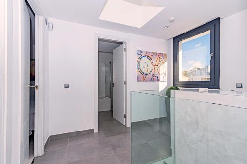 a white kitchen with a glass counter and a window at Beach Villa Cosins 1 Mel by Sealand Villas in Alcudia