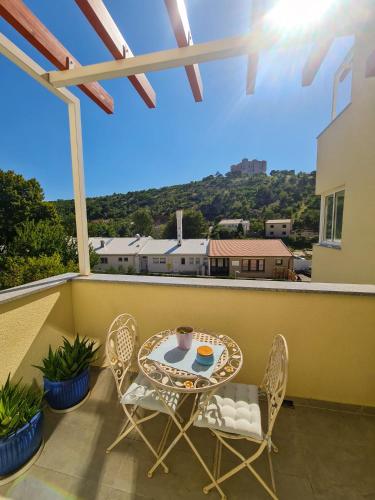 a patio with a table and chairs on a balcony at Apartment TORRE - NEW in Senj