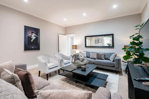 a living room with a couch and a table at Hampstead Garden Flat-Hosted by Sweetstay in London