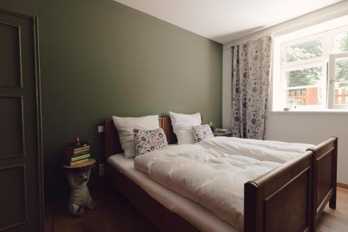 a bedroom with a large bed with a window at Flecksches Gut in Leipzig
