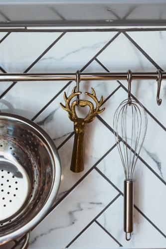 a kitchen counter with a whisk and a sink at Flecksches Gut in Leipzig
