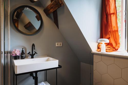a bathroom with a sink and a mirror at Flecksches Gut in Leipzig