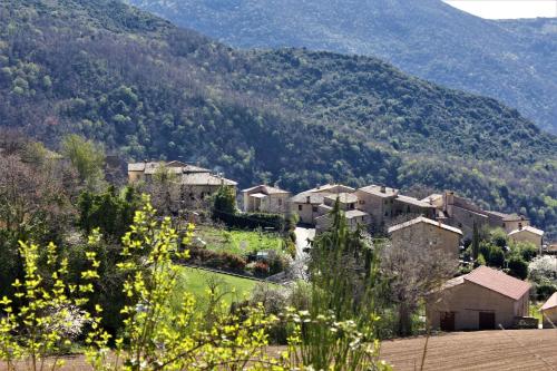 a small town in a valley with a mountain at Il Rustico di Meggiano in Meggiano