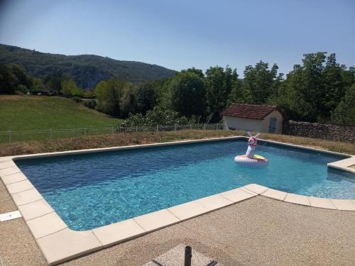 a swimming pool with a raft and a inflatable raft at Gite st cirq Lapopie piscine vue imprenable in Tour-de-Faure